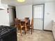 Eat-in kitchen features a dining table, matching chairs and ample cabinet space, creating a functional space at 1804 W 15Th St, Muncie, IN 47302