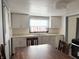 This bright eat-in kitchen features a dining table and chairs with ample cabinet space at 1804 W 15Th St, Muncie, IN 47302