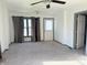 Bright living room with new carpet, neutral walls, ceiling fan and large windows, creating an inviting atmosphere at 1804 W 15Th St, Muncie, IN 47302