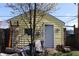 Charming yellow backyard shed has storage, ladder, and outdoor decor at 2025 Barth Ave, Indianapolis, IN 46203