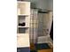 Bathroom with bathtub, shower curtain, sink, and built-in shelving for linens and toiletries at 2025 Barth Ave, Indianapolis, IN 46203