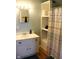 Bright bathroom featuring a shower-tub, sink with vanity, decorative mirror, and shelving at 2025 Barth Ave, Indianapolis, IN 46203