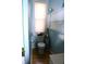 Small bathroom with a toilet, window, and shelving for storage and a door to the hall at 2025 Barth Ave, Indianapolis, IN 46203