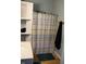 Bathroom with bathtub, shower curtain, sink, and built-in shelving for linens and toiletries at 2025 Barth Ave, Indianapolis, IN 46203