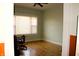 Cozy bedroom featuring wood floors, a ceiling fan, and a bright window for natural light at 2025 Barth Ave, Indianapolis, IN 46203