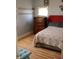 Inviting bedroom with wood floors, a double bed, and shelving for convenient storage at 2025 Barth Ave, Indianapolis, IN 46203