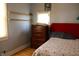 Cozy bedroom features warm hardwood floors, shelving, and a comfortable bed at 2025 Barth Ave, Indianapolis, IN 46203