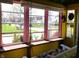 Relaxing sunroom with porch swing and large windows with peaceful views at 2025 Barth Ave, Indianapolis, IN 46203
