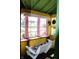 Cozy porch with swing, pink framed windows, and natural lighting at 2025 Barth Ave, Indianapolis, IN 46203