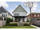 Exterior of home featuring a covered patio with outdoor seating and manicured landscaping at 2134 N New Jersey St, Indianapolis, IN 46202