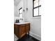 Stylish half-bath with dark wood vanity, brass fixtures, and a modern aesthetic at 2134 N New Jersey St, Indianapolis, IN 46202