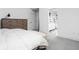 Modern bedroom featuring a dresser and an ensuite bathroom with a stylish chevron-patterned floor at 2134 N New Jersey St, Indianapolis, IN 46202