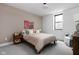 Cozy bedroom with queen bed, neutral decor, and colorful artwork on the beige painted accent wall at 2134 N New Jersey St, Indianapolis, IN 46202