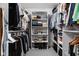 Organized walk-in closet with shelving, rods, and ample storage space for clothes and shoes at 2134 N New Jersey St, Indianapolis, IN 46202