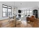 Elegant dining area with a glass table, modern chairs, hardwood floors, and large windows at 2134 N New Jersey St, Indianapolis, IN 46202