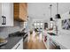 Contemporary kitchen with stainless steel appliances, gray countertops and a stylish wood range hood at 2134 N New Jersey St, Indianapolis, IN 46202