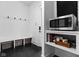 Organized mudroom with built-in bench, storage baskets, and a convenient microwave station at 2134 N New Jersey St, Indianapolis, IN 46202