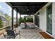 Covered patio with herringbone floors, ceiling fans, and comfortable seating, perfect for outdoor relaxation at 2134 N New Jersey St, Indianapolis, IN 46202