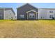 Spacious backyard featuring a green lawn and a view of neighboring houses, set on a sunny day at 2250 Egbert Rd, Westfield, IN 46074