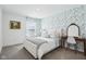 Stylized bedroom with a queen bed, vibrant wallpaper, and a charming vanity set, designed for relaxation and comfort at 2250 Egbert Rd, Westfield, IN 46074