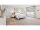 Spacious bedroom with natural light, soft carpeting, a cozy queen bed, and tasteful decor, creating a serene retreat at 2250 Egbert Rd, Westfield, IN 46074