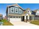 Charming two-story home with blue siding, white garage door, and brick accents, complete with a well-maintained lawn at 2250 Egbert Rd, Westfield, IN 46074