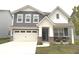 Charming two-story home with blue and white siding, a well-manicured lawn, and a two car garage at 2250 Egbert Rd, Westfield, IN 46074