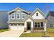 Charming two-story home showcasing a blend of blue and white siding with well-manicured lawn and a two car garage at 2250 Egbert Rd, Westfield, IN 46074