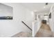 Bright hallway with neutral paint, carpet and railing leading to an open-concept living space, perfect for modern living at 2250 Egbert Rd, Westfield, IN 46074