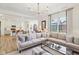 Spacious living area featuring a large sectional sofa, modern lighting, and seamless transition to the kitchen at 2250 Egbert Rd, Westfield, IN 46074