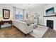 Bright living room featuring a neutral sofa, chandelier, fireplace, striped wallpaper, and wood flooring at 2250 Egbert Rd, Westfield, IN 46074
