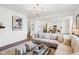 Bright living area featuring a large sectional sofa, modern lighting, and seamless transition to the kitchen and stairs at 2250 Egbert Rd, Westfield, IN 46074