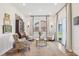 Inviting sitting room with patterned chairs, a glass table, decorative rug, and sliding doors leading to outdoor space at 2250 Egbert Rd, Westfield, IN 46074