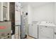 Organized utility room equipped with a modern washer, dryer, and water heater, ensuring convenience and efficiency at 2250 Egbert Rd, Westfield, IN 46074