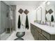 Modern bathroom features a double vanity, a glass-enclosed shower, and neutral decor at 2263 N Delaware St, Indianapolis, IN 46205