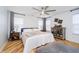 Bright bedroom features hardwood floors, a ceiling fan, and a stylish accent cabinet at 2263 N Delaware St, Indianapolis, IN 46205