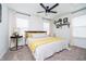 Relaxing bedroom with a ceiling fan, natural light, and decorative shelving at 2263 N Delaware St, Indianapolis, IN 46205