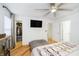 Well-lit bedroom showing closet and adjacent doorways, TV, and modern ceiling fan at 2263 N Delaware St, Indianapolis, IN 46205
