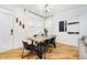 Modern dining room with hardwood floors, statement lighting, and a rustic wood table at 2263 N Delaware St, Indianapolis, IN 46205