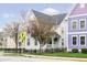 Two story home with black metal fencing and mature landscaping and pedestrian sign at 2263 N Delaware St, Indianapolis, IN 46205