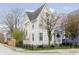 Charming two-story home with flowering tree in the front yard, black metal fence at 2263 N Delaware St, Indianapolis, IN 46205