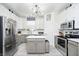 Bright kitchen features white cabinets, stainless steel appliances and center island at 2263 N Delaware St, Indianapolis, IN 46205