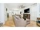 Bright living room with neutral decor, hardwood floors, large sofa and stylish ceiling fan at 2263 N Delaware St, Indianapolis, IN 46205