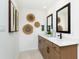Elegant bathroom with double vanities, modern fixtures, and decorative wall art at 261 Onset Way, Westfield, IN 46074