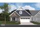 Charming home with a stone and siding exterior, two-car garage, and landscaped front yard at 261 Onset Way, Westfield, IN 46074