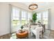 Bright living room features large windows with scenic views, stylish seating, and contemporary light fixture at 261 Onset Way, Westfield, IN 46074