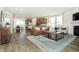 Open-concept living room with kitchen, dining area, modern decor, and abundant natural light at 261 Onset Way, Westfield, IN 46074