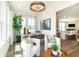 Cozy living room with modern furniture, a decorative light fixture, and an open view to the kitchen at 261 Onset Way, Westfield, IN 46074
