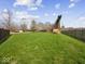 Spacious backyard with lush green grass and mature trees, perfect for outdoor activities at 2810 Winterway Dr, Shelbyville, IN 46176