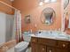 This bathroom features a wooden vanity, large mirror, and a tub-shower combination with a plaid shower curtain at 2810 Winterway Dr, Shelbyville, IN 46176
